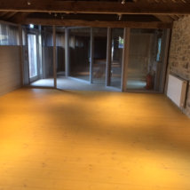 A new pine floor in the main entrance area after a mustard coloured finish.